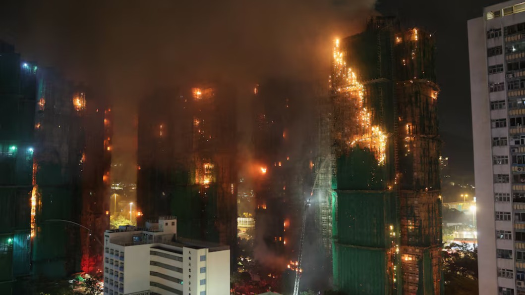 Hong Kong high-rise engulfed in flames with bamboo scaffolding and safety nets catching fire